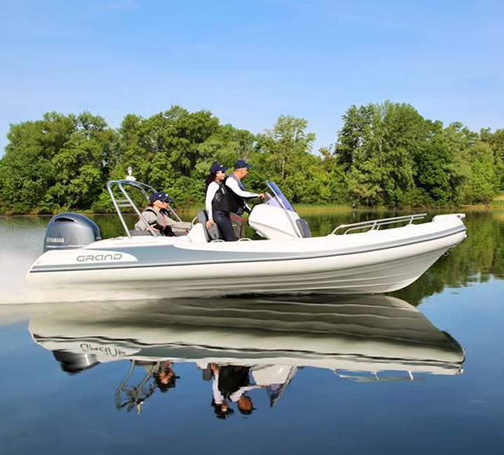 Four passengers travelling on the water in the Grand G580