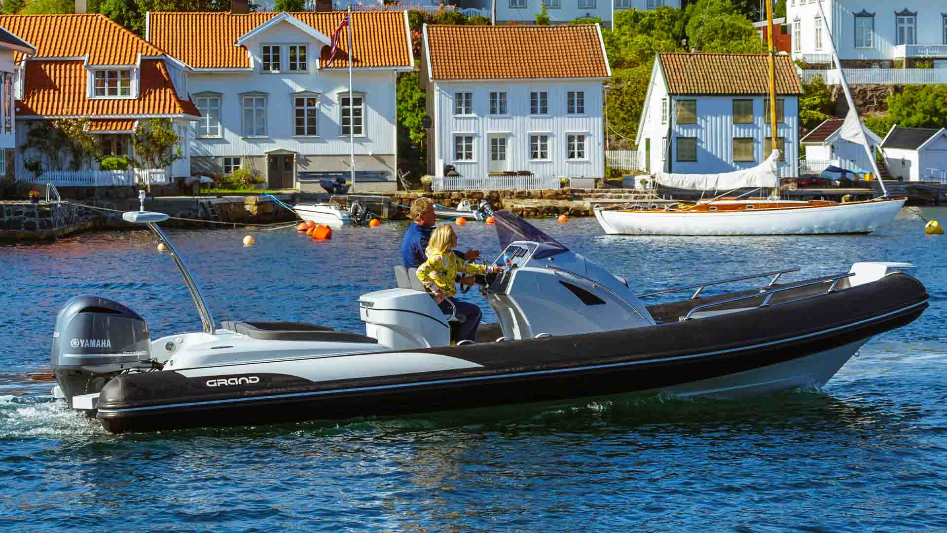 Two passengers travelling on board the Grand G850, a bestselling rigid inflatable boat