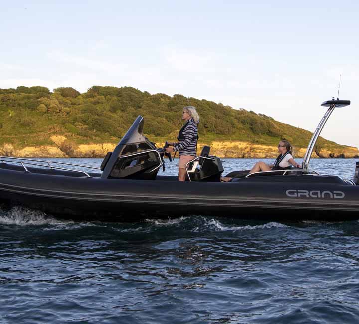 Two passengers travelling in the Grand G750 at sunset