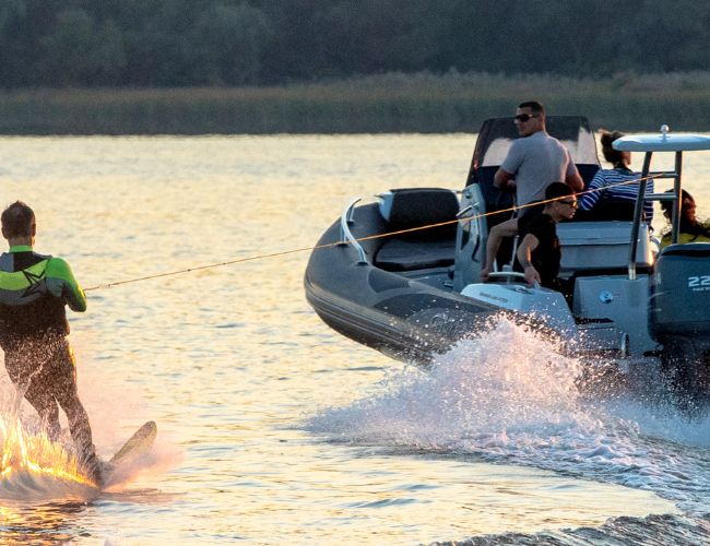 A man waterskiing behind the Grand G750