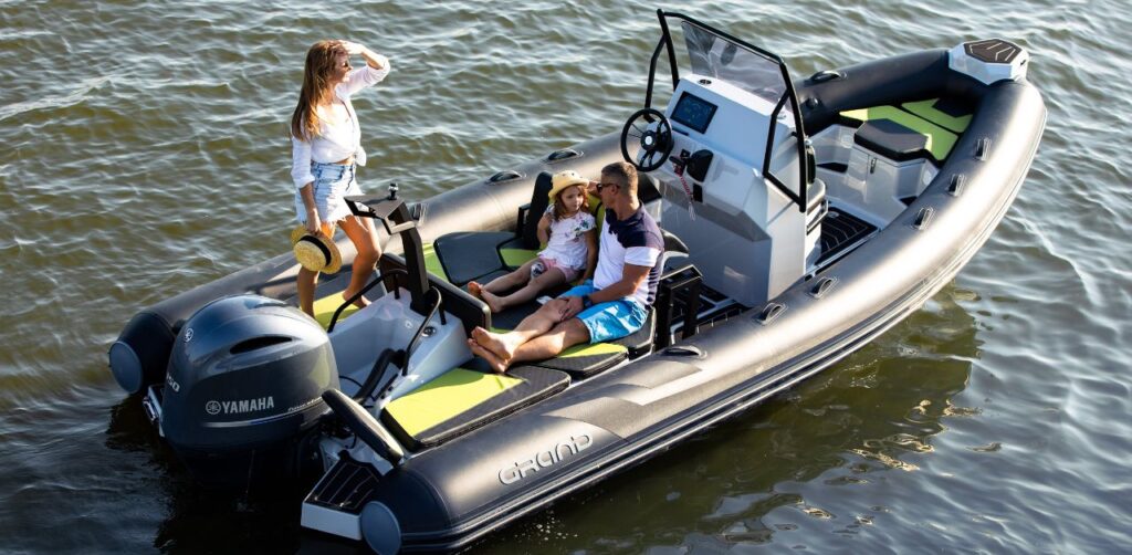 A family sat in the sun onboard the Grand D600 - a bestselling rigid inflatable family boat