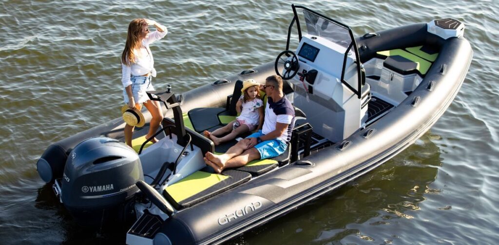 A family sat in the sun onboard the Grand D600 - a bestselling rigid inflatable family boat