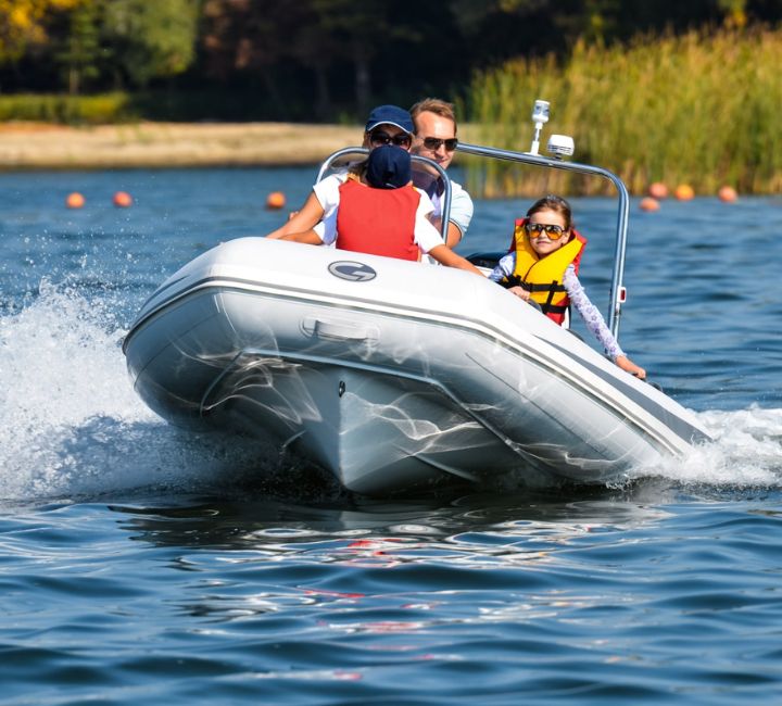 A family of four onboard a Grand S420, travelling on the water