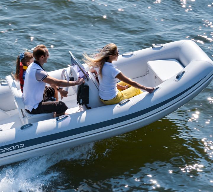 A family of four onboard a Grand S420, travelling on the water in a boat