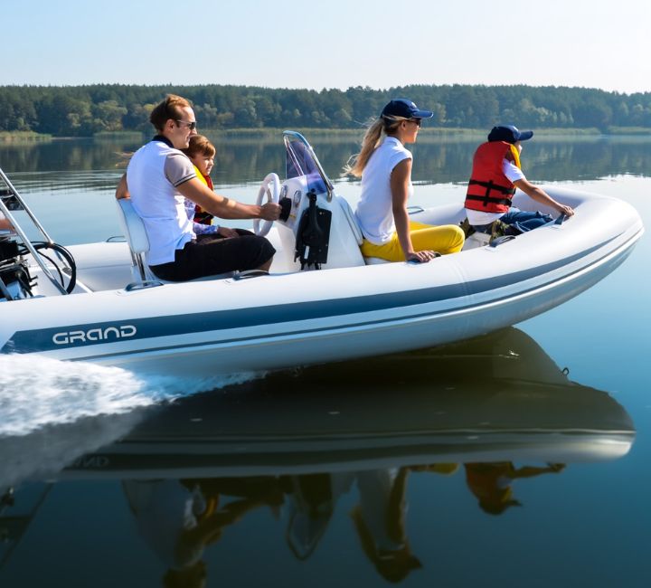 A family of four onboard a Grand S420, travelling on the water in a boat together