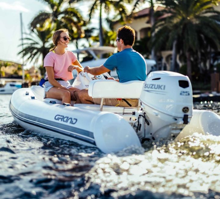 A white S330 with two passengers onboard travelling through canals