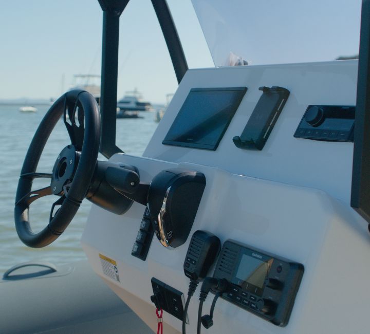 The dashboard on the Grand D600 with Garmin screens, phone charger, and Fusion speaker system