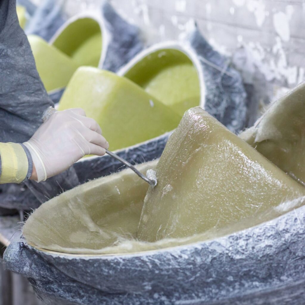 A Grand Inflatable Boats employee doing fibreglass work