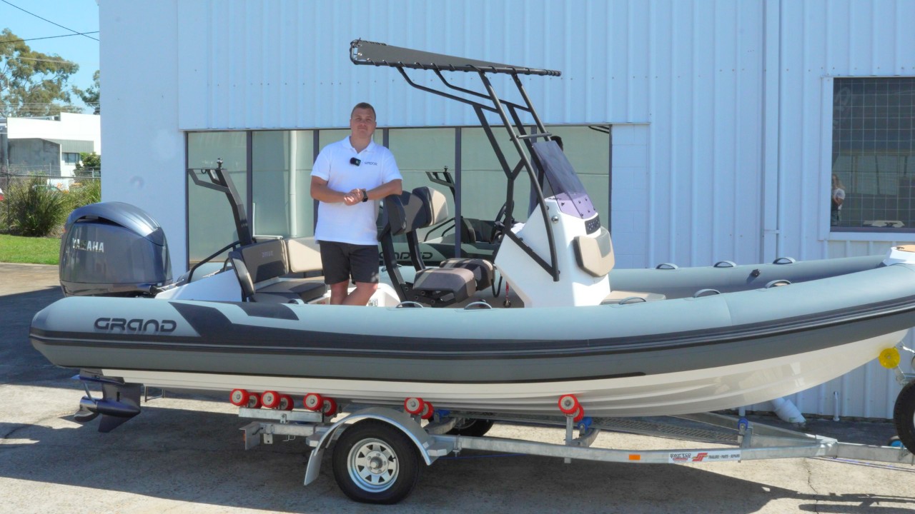 A man stood on a rigid inflatable boat, doing a boat walkthrough of the Grand D600