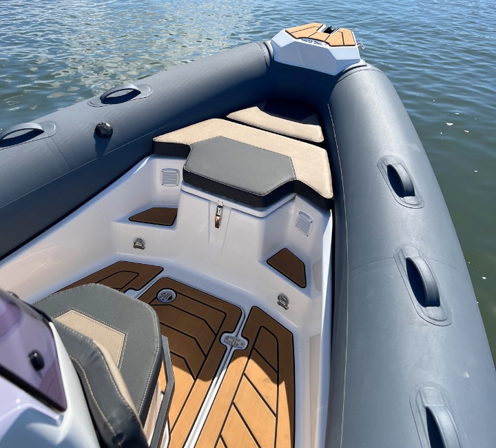 The bow of a dark grey rigid inflatable boat