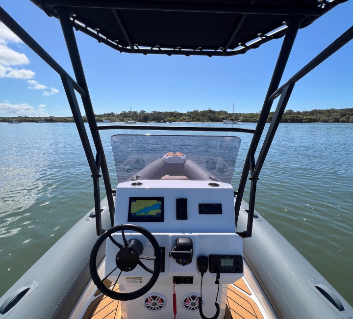 The centre console on a grey rigid inflatable boat, underneath a t-top