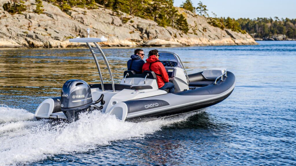 A Grand G580 on the water in Norway with two passengers on board