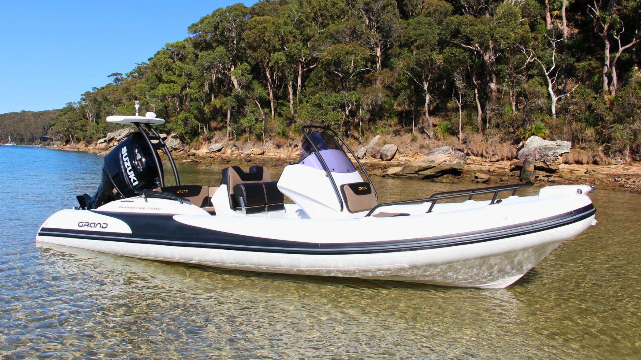 A white Grand G580 boat sat on the water