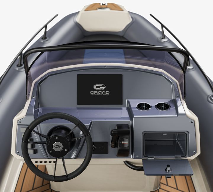 A render visual of the Grand G580 console with steering wheel, chart plotter screen and glove bxox