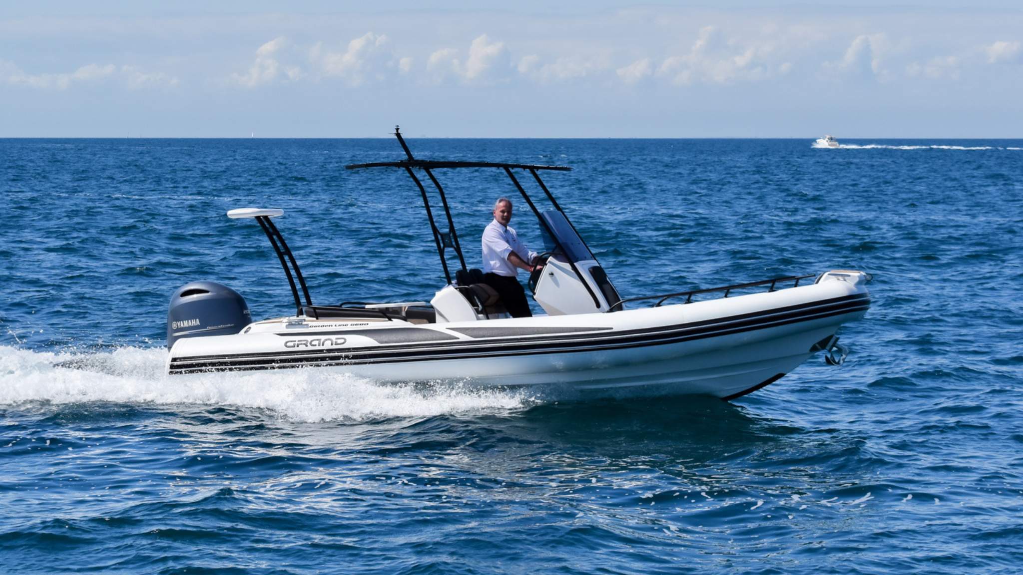 A Grand G680 rigid inflatable boat on the water with a driver on board