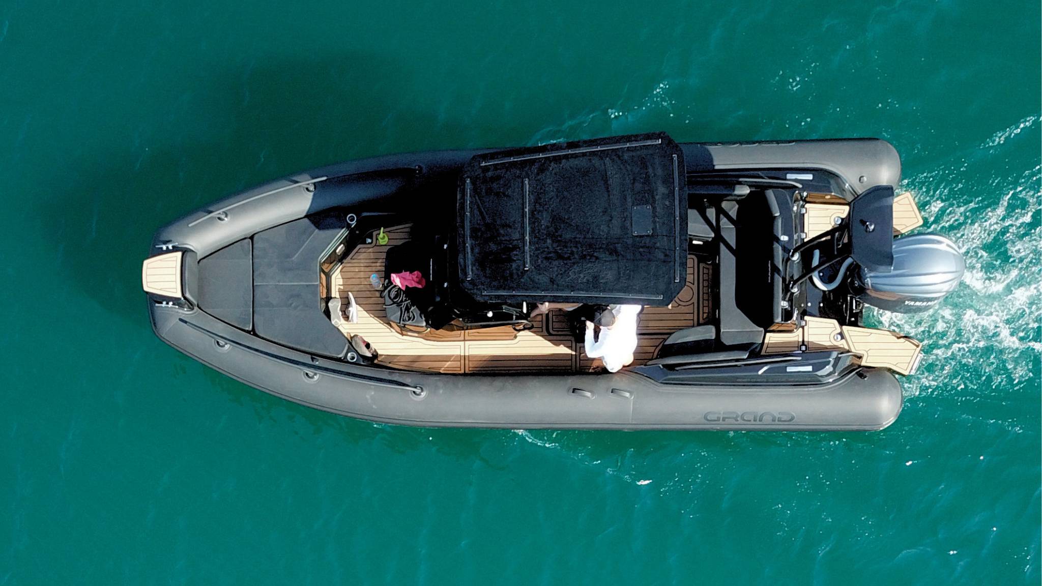 A Grand G750 rigid inflatable boat on the water with a black t-top