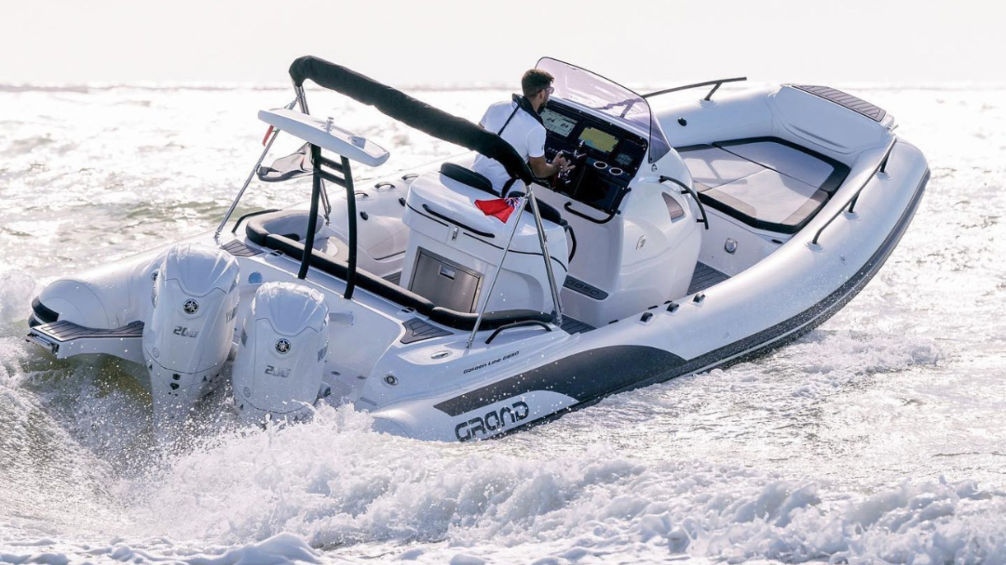 A Grand G850 rigid inflatable boat with white tubes travelling through the water