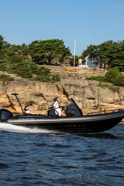 A Grand G750 rigid inflatable boat on the water with a family on board