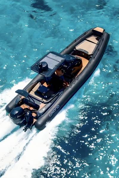 A Grand G850 rigid inflatable boat with black tubes travelling through blue water