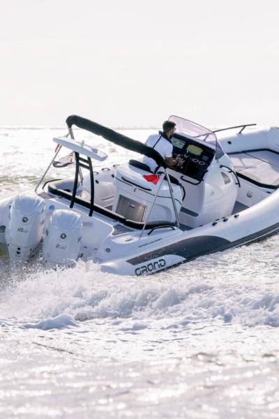 A Grand G850 rigid inflatable boat with white tubes travelling through the water