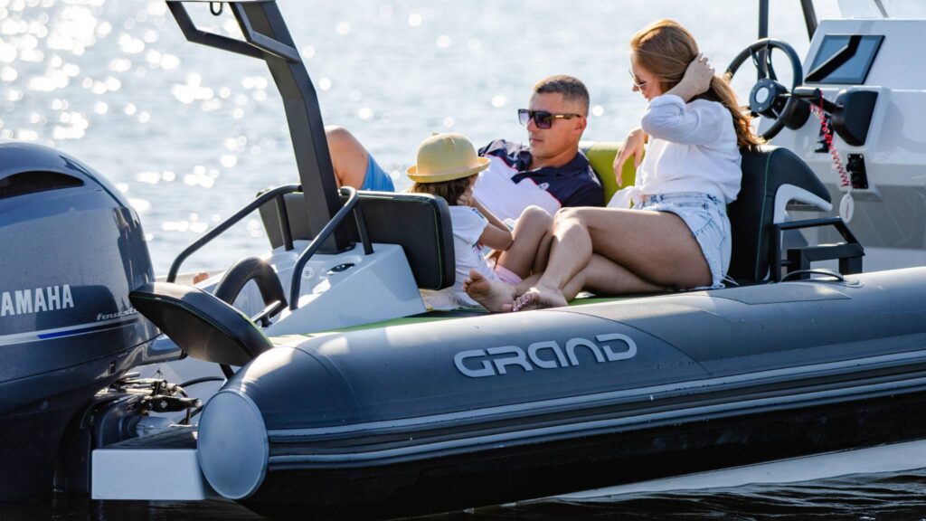 A family sat onboard a Grand D600 rigid inflatable boat