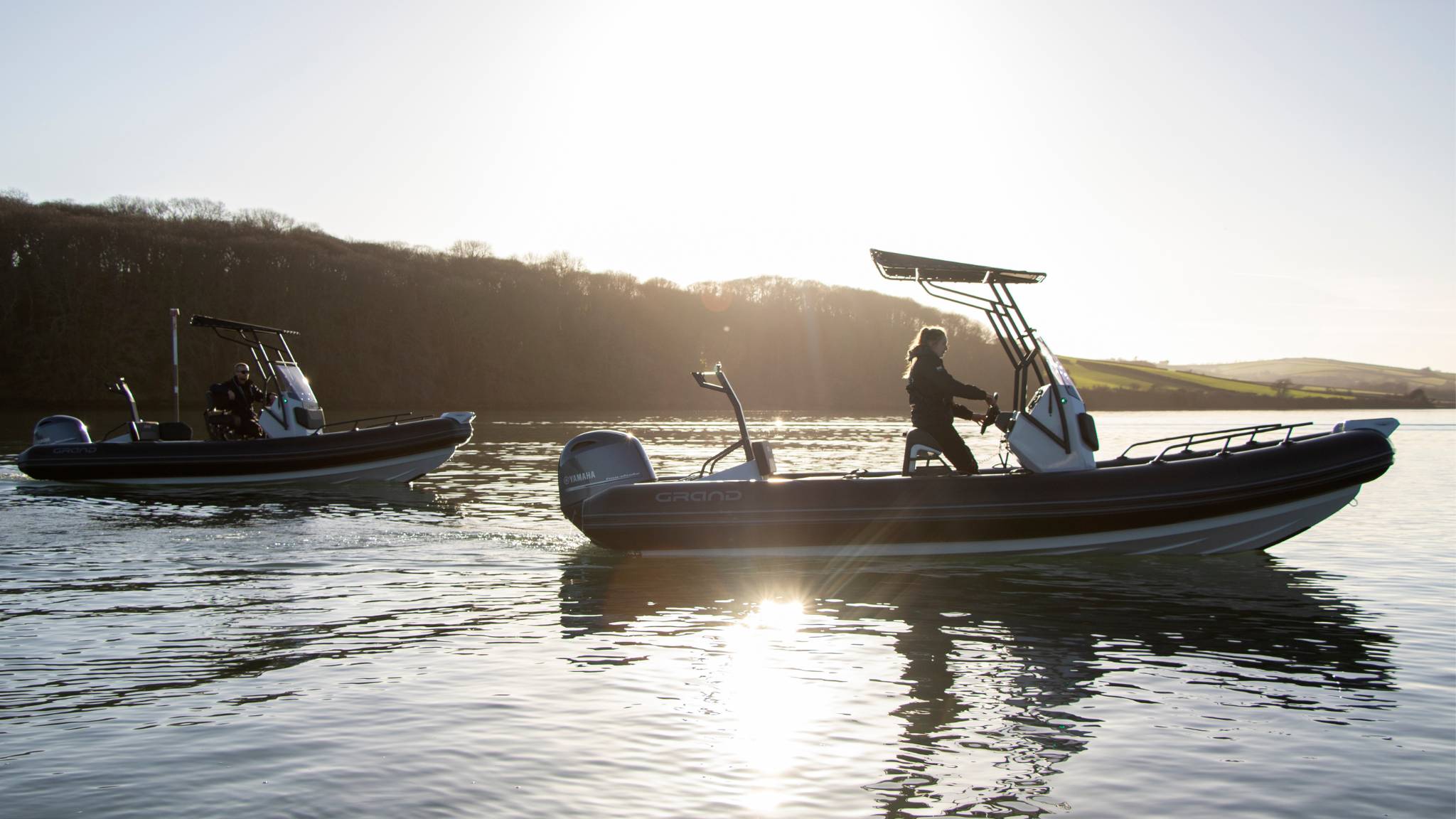 Two Grand D600 boats on the water in the sun