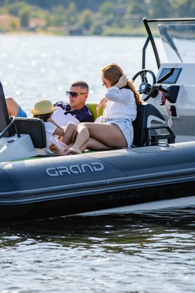 A family sat onboard a Grand D600 rigid inflatable boat