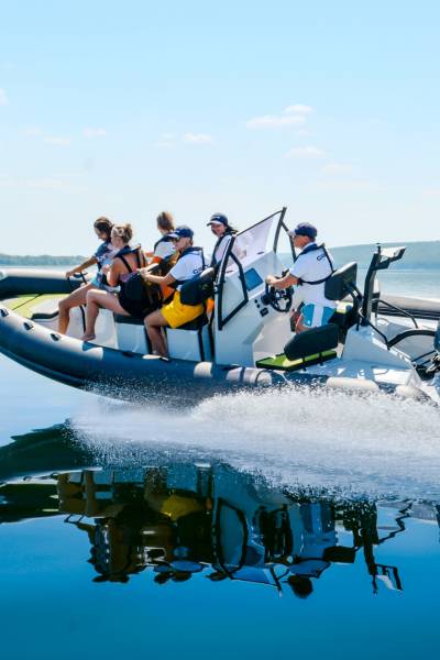 A Grand D600 rigid inflatable boat travelling through the water with 6 passengers on board