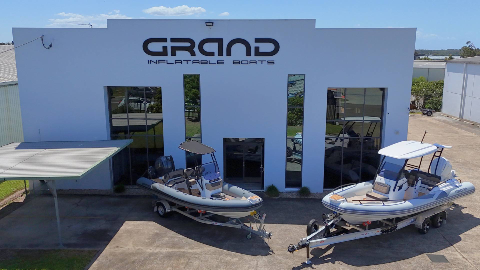 Grand Rigid Inflatable Boat Dealership with two boats outside