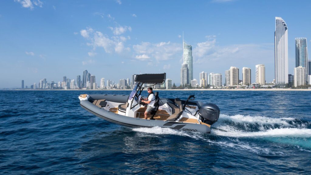 A 6 metre rigid inflatable boat travelling past the Gold Coast skyline on the water