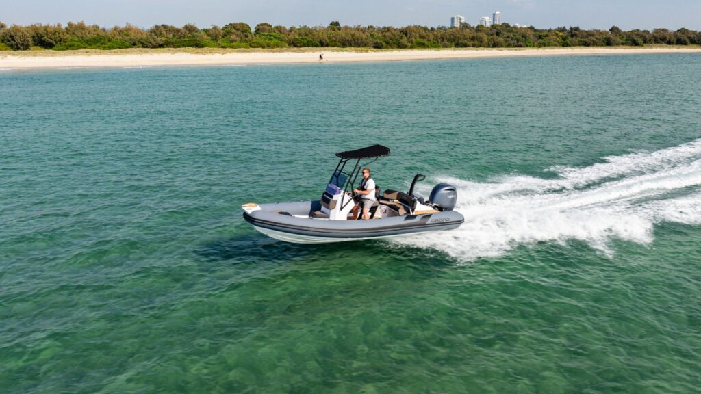 A grey Grand D600 rigid inflatable boat travelling on the water