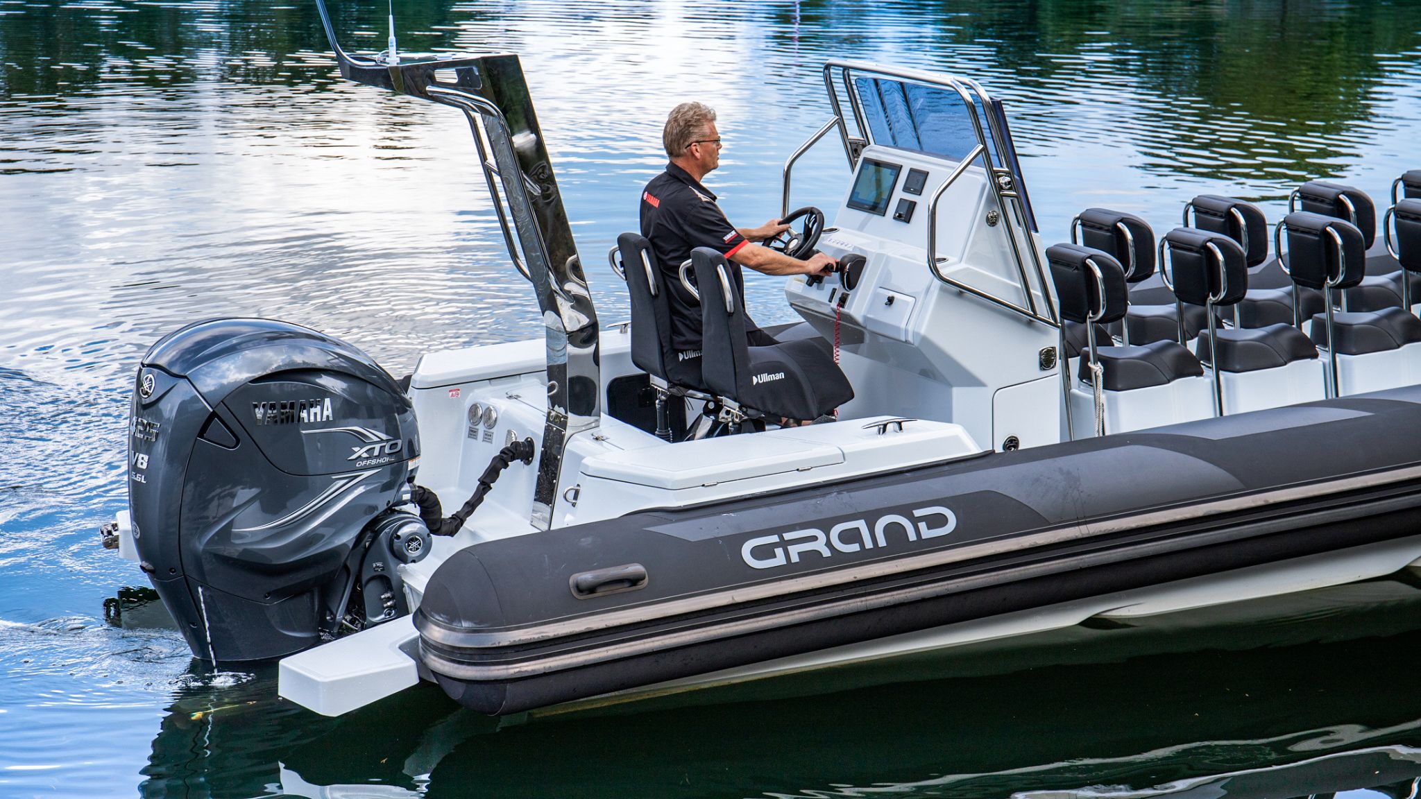 A man at the helm of the Grand D950 commercial rigid inflatable boat