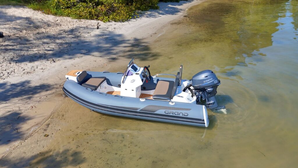 Grand G340 tender boat beached on the sand