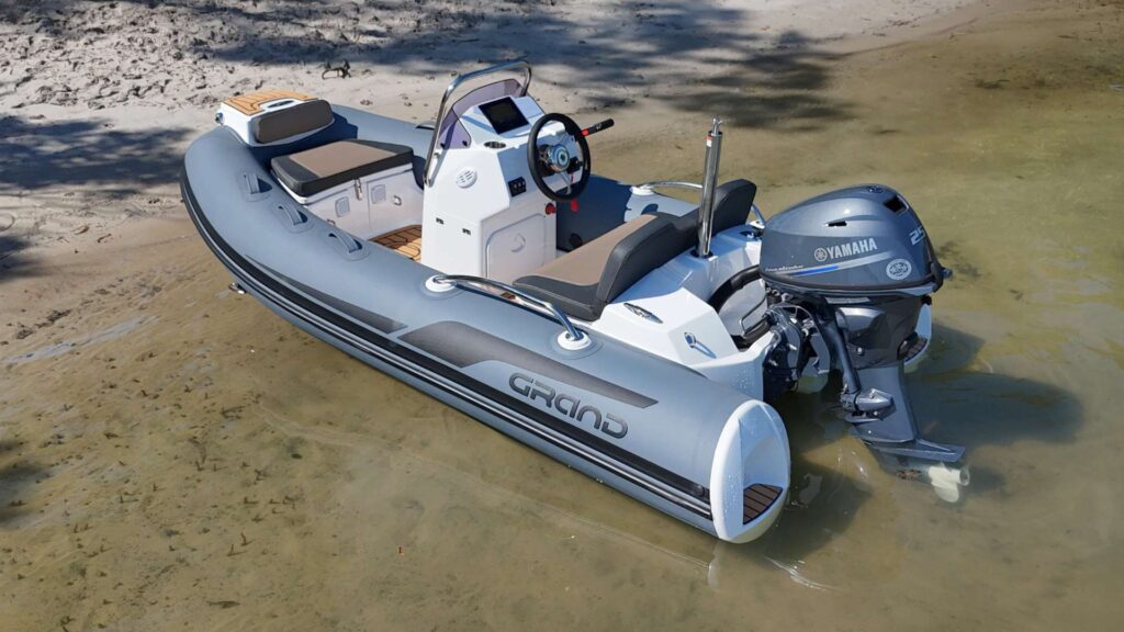 The Grand G340 tender boat beached on the sand in clear water