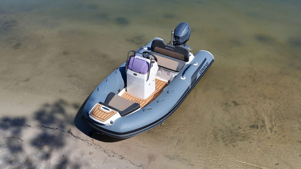 The Grand G340 tender boat beached on the sand in clear water
