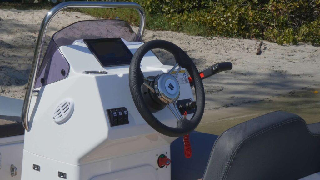 The Grand G340 tender boat steering console with steering wheel and Garmin Chart Plotter