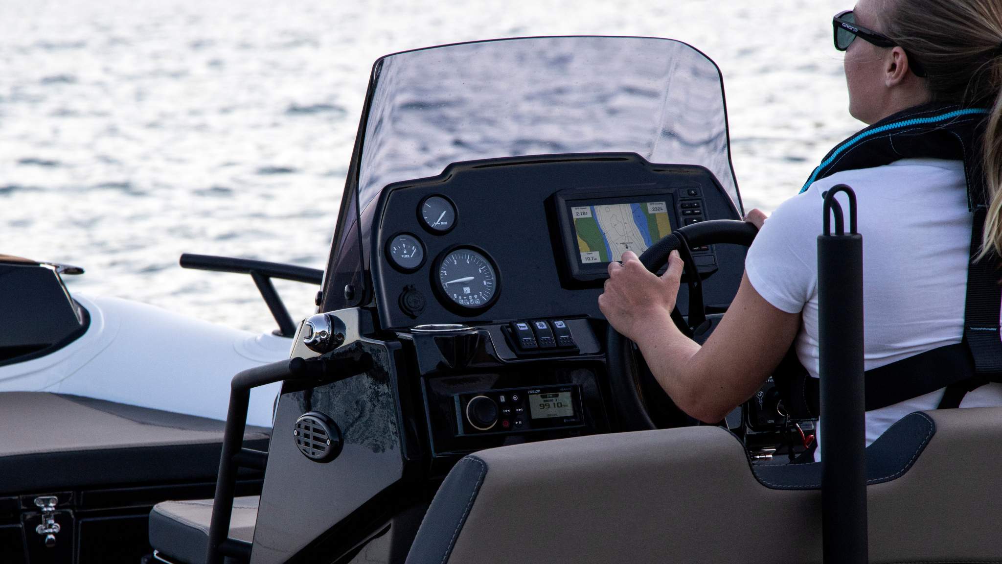 A woman driving a Grand G420 tender boat