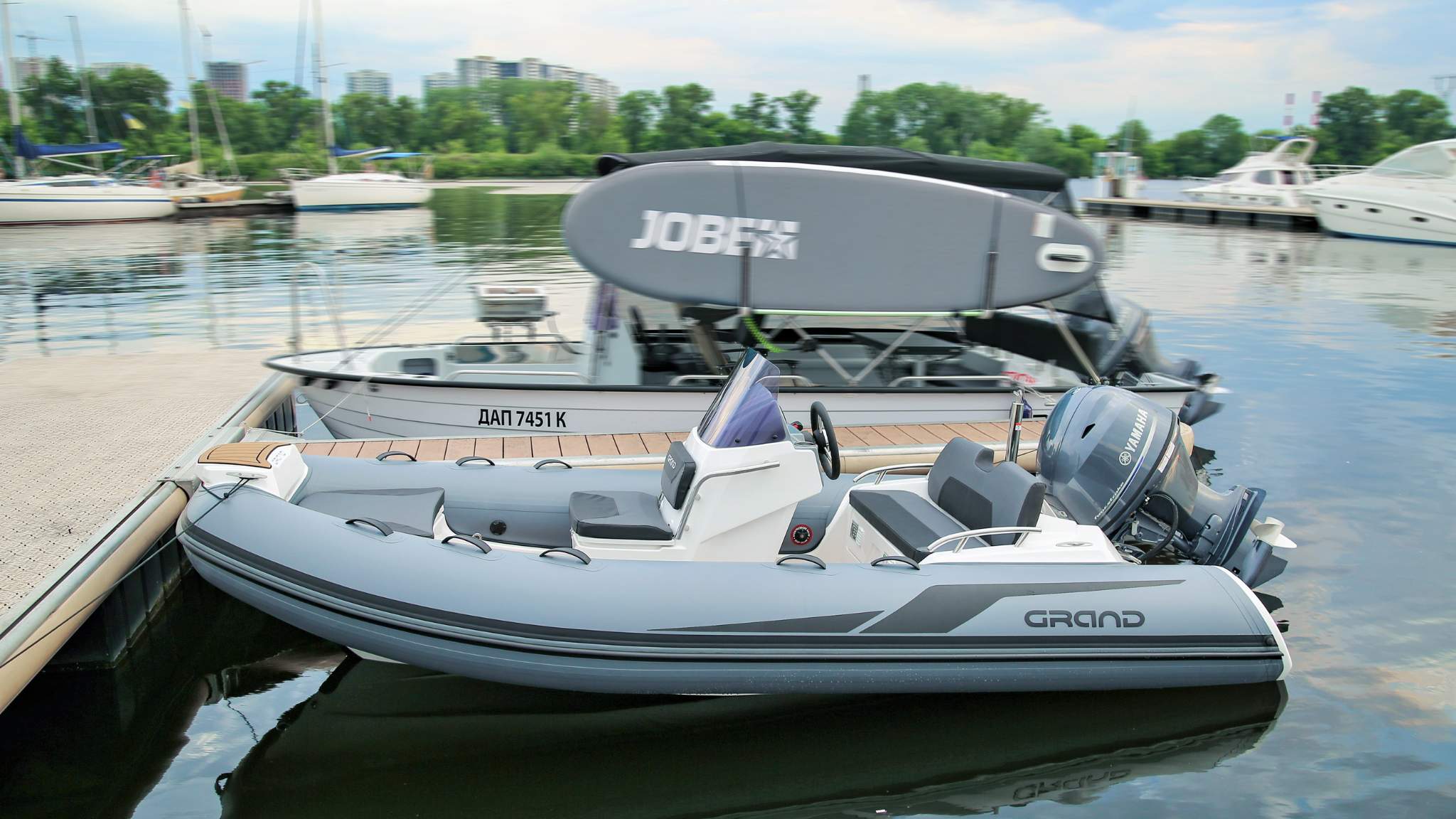 A Grand G420 boat sat on the water near a pontoon