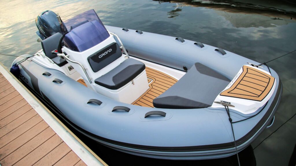 A Grand G420 boat sat on the water near a pontoon