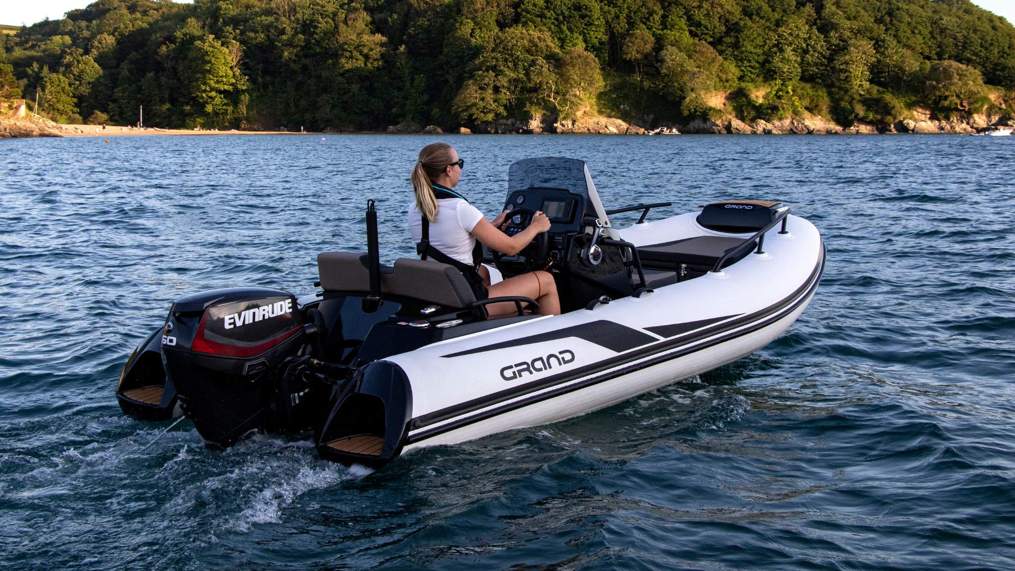 A woman driving the Grand G420 tender boat