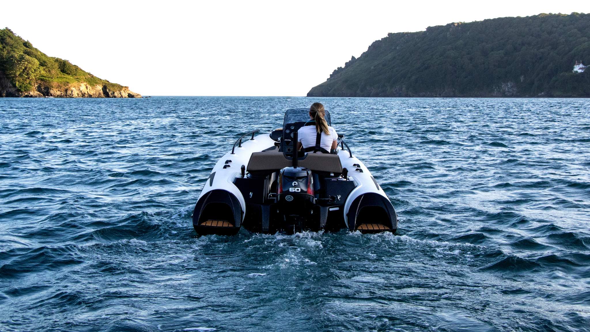 A woman driving the Grand G420 tender boat