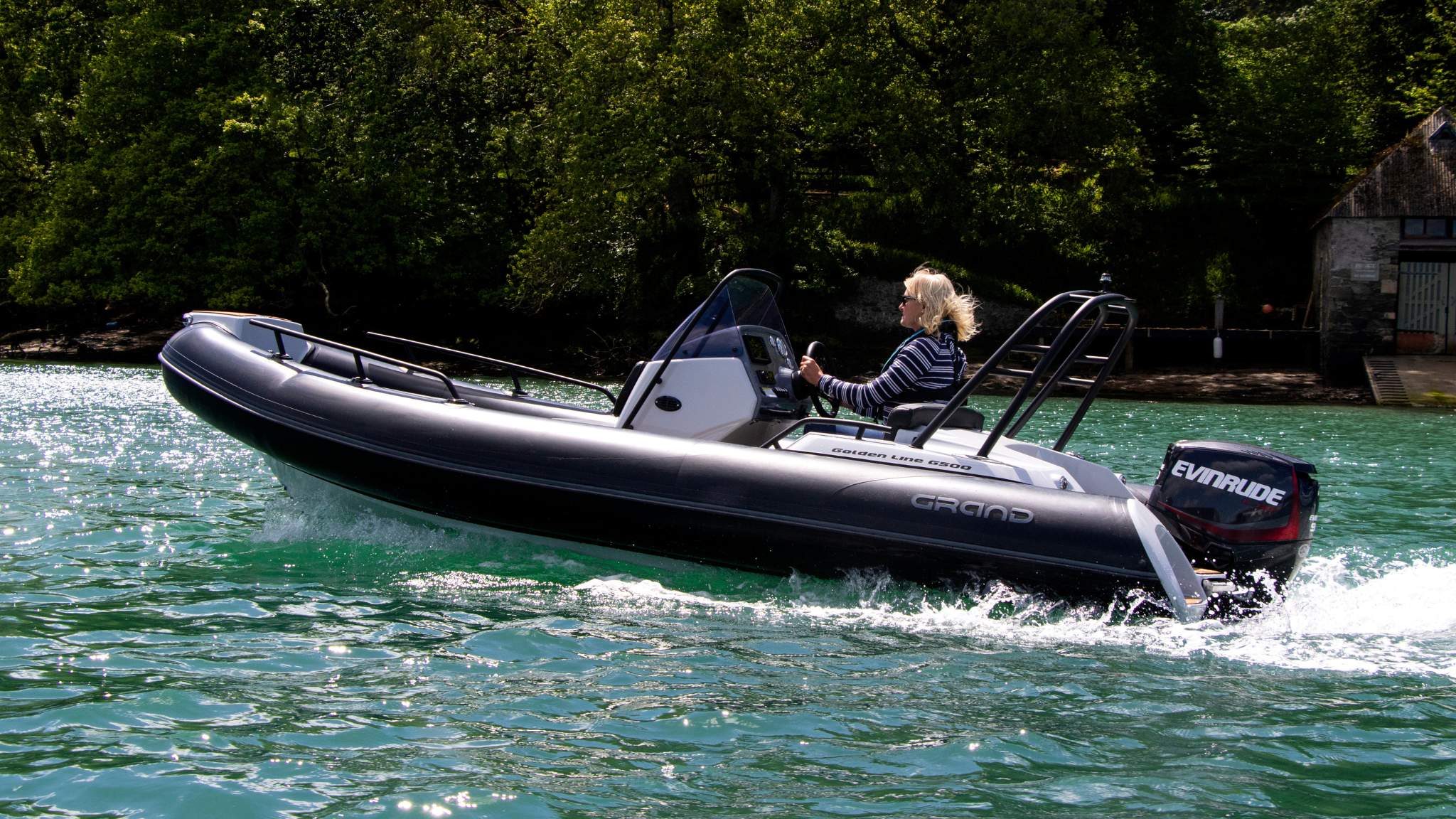 A woman driving the Grand G500 boat