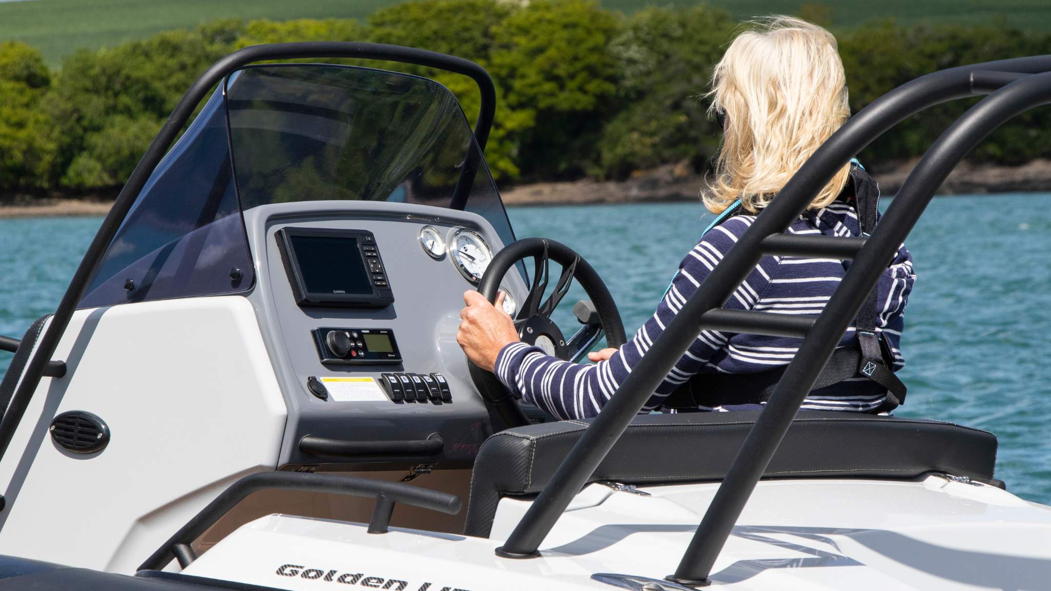 A woman driving the Grand G500 rigid inflatable boat