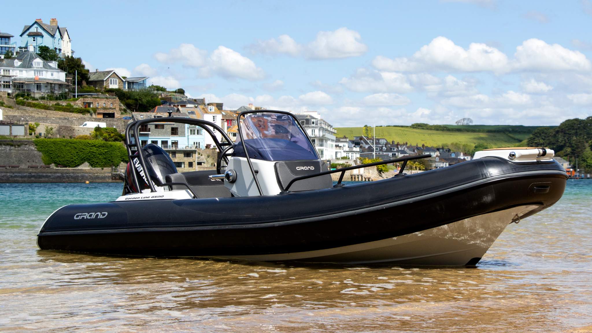 A Grand G500 boat sat on the sand in a harbour