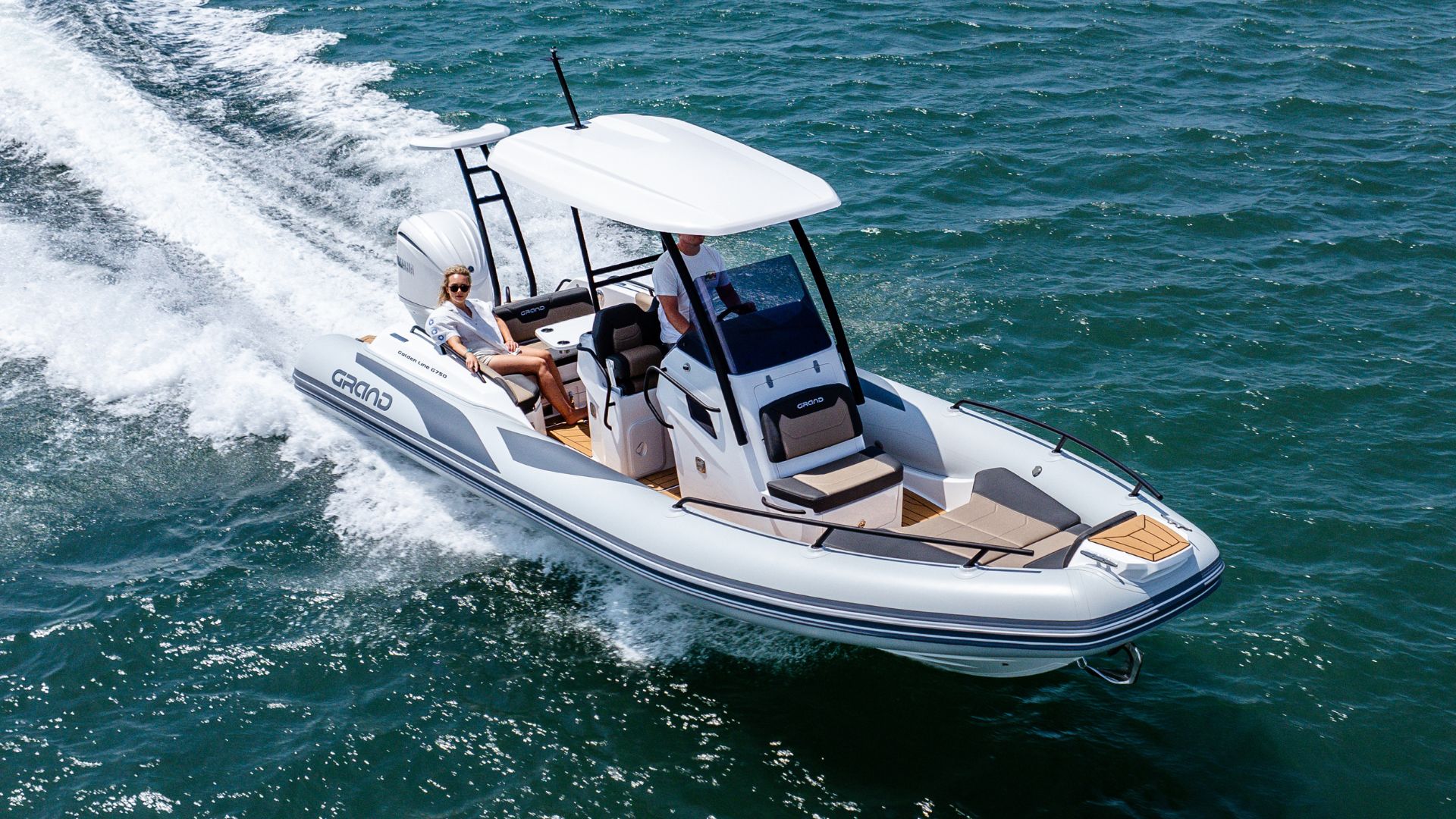 Grand G750 rigid inflatable boat on the water with two passengers