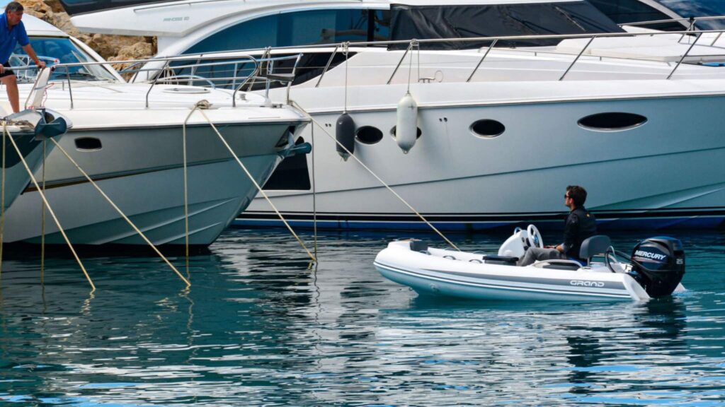 The Grand S300 tender boat next to a motor yacht