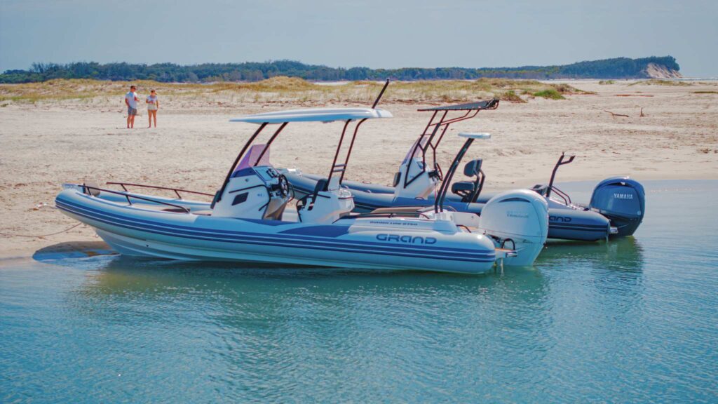 Two Grand rigid inflatable boats beached on the sand