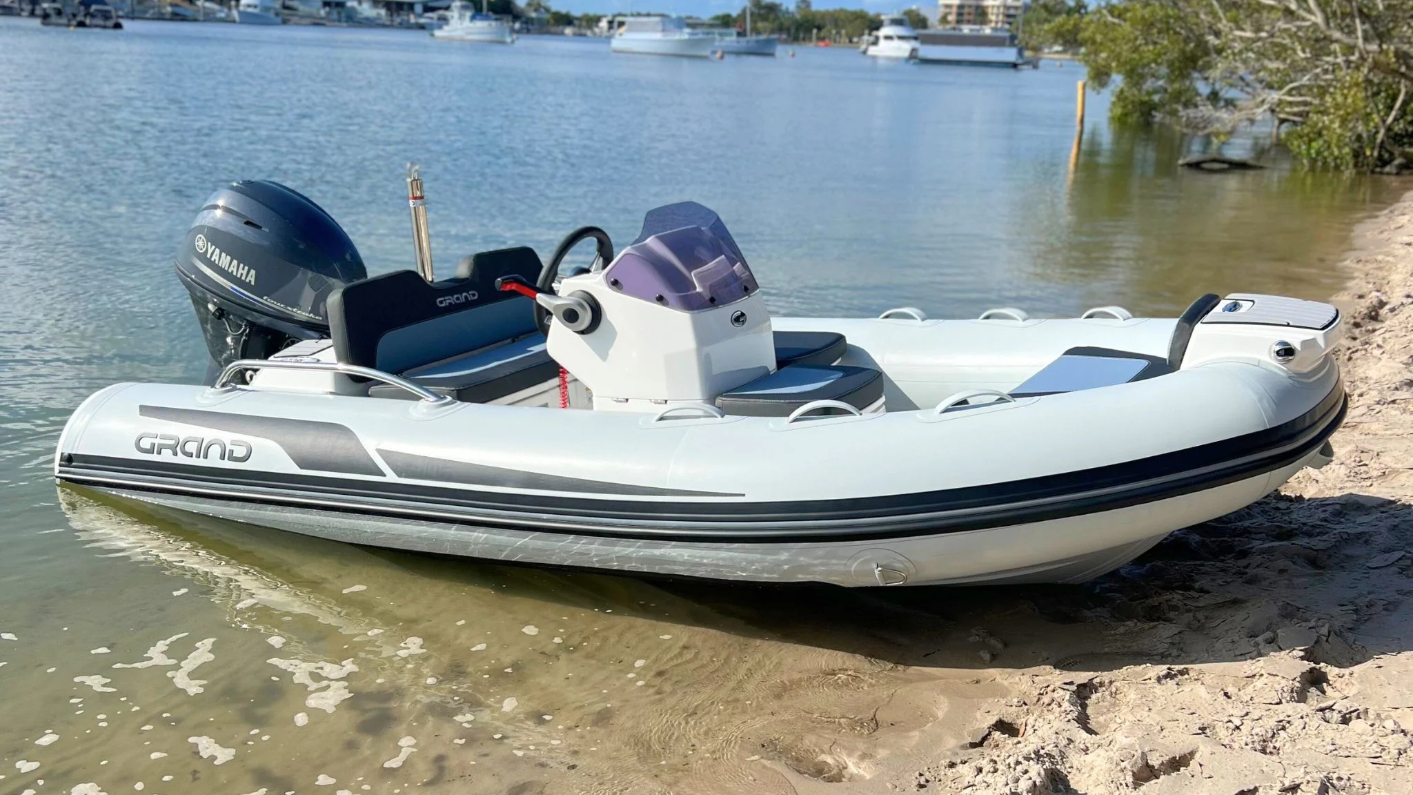 A Grand G380 tender boat beached on the sand