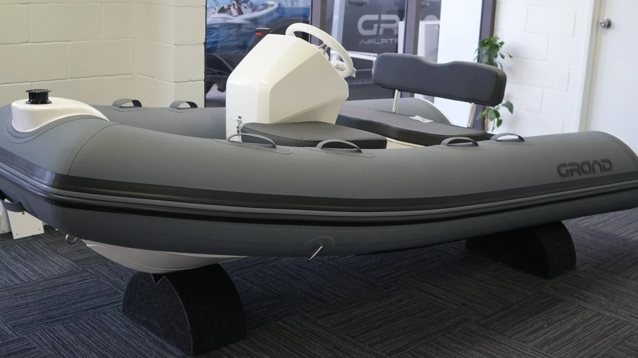 Grand S330 tender boat on display in a showroom