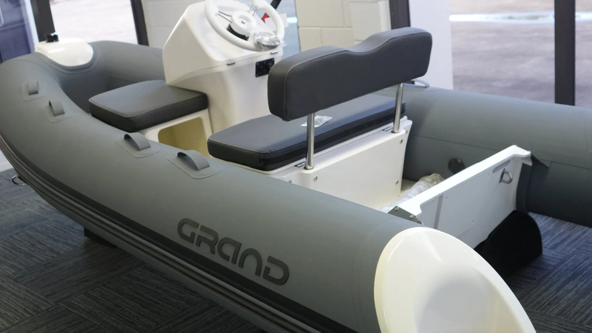 Grand S330 tender boat on display in a showroom